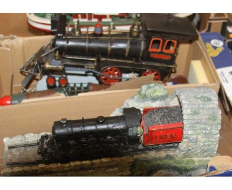 A collection of resin and tinplate model ornaments to include a tinplate model of a Spitfire, an American Outline steam train