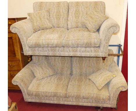 A contemporary Parker Knoll floral decorated two-piece suite, comprising; three-seater sofa and a two-seater sofa, each with 