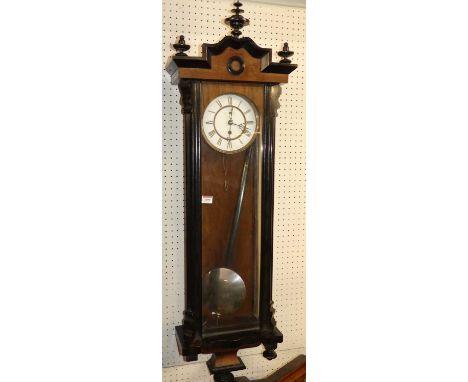 An early Victorian walnut and ebonised Vienna wall clock circa 1840, having a white enamel dial (with hairline), single weigh