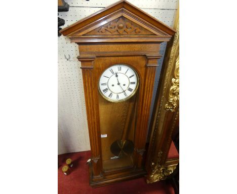 A late 19th century oak cased Vienna wall clock by Lenzkirk, having an unsigned white enamel Roman dial with rare twin train,