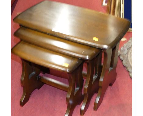 An Ercol dark elm nest of three occasional tables, the largest width 57cm