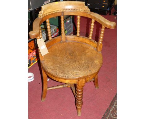 An early 20th century elm and fruitwood tub captain's chair, having bobbin turned uprights, width 62.5cm