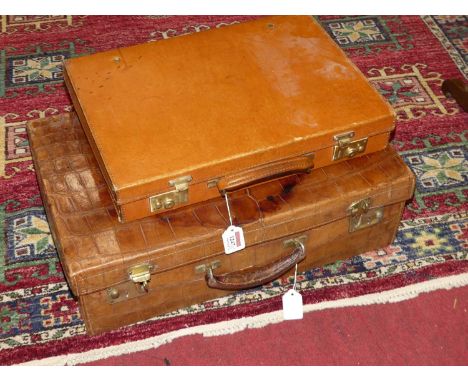 An early 20th century vintage crocodile skin suitcase, width 56cm, together with a further early 20th century tan leather doc