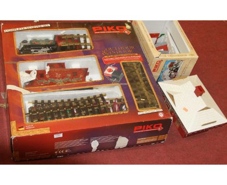 A Piko G scale Christmas related train set comprising of locomotive, open wagon and caboose, together with a quantity of Piko