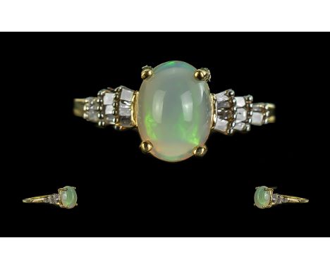 Opal and Diamond Ballerina Ring, a central, oval cabochon cut opal, flanked by three graduating rows of baguette cut diamonds