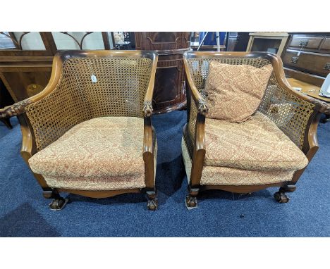 Two Matching Bergere armchairs.  Carved wooden arms, claw feet, Canework is in good condition on these solid comfortable chai