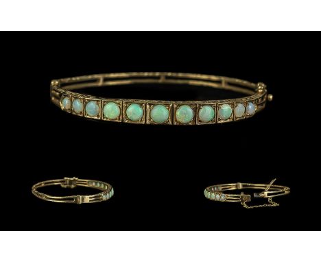 Ladies Attractive Edwardian Period 1902 - 1910 Opal Set Hinged Bangle with Safety Chain. Set with 13 Graduated Opals of Excel