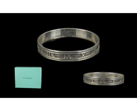 Tiffany &amp; Co Bangle In Silver. Solid Silver Tiffany Bangle with Roman Numeral Decoration, Comes In Original Packaging. 
