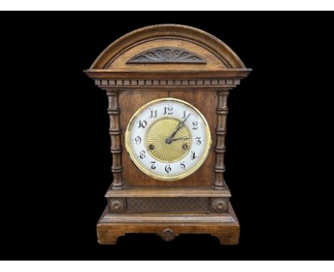 An Edwardian Wooden Mantle Clock, white enamel chapter dial with Arabic numerals.  Height 14''.