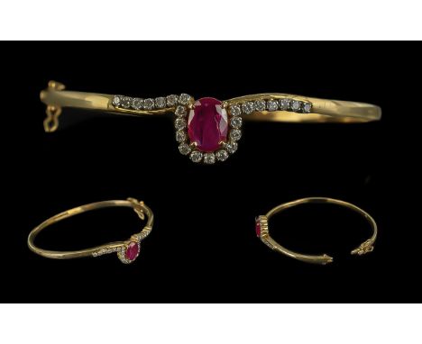 A Fine Quality - Attractive 9ct Gold Ruby and Diamond Set Hinged Bangle. Marked 9ct. The Large Faceted Ruby of Good Colour, E