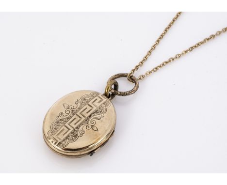 An Edwardian enamel and gold plated oval locket, with blue, black and white monogram initials, the reverse marked with Greek 