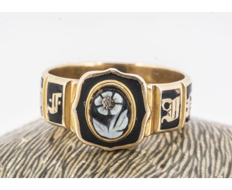 A 19th century mourning ring, enamel shank, sardonyx onyx forget me not carved set panel, inner shank engraved M.R. Macdonell