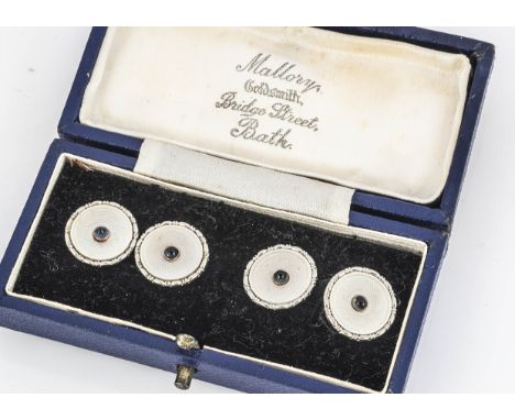 A pair of 9ct gold enamel and paste set circular cufflinks, of circular design, centred with blue cabochon paste, in Mallory 
