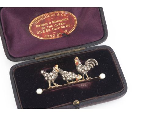 A late 19th century diamond encrusted, enamel and ruby eyed chicken and cockerel brooch, modelled on a pearl terminated recta