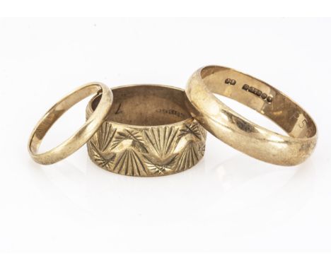 Three 9ct gold wedding bands, A textured example, a large D shape and another, ring sizes Z,Q&amp;K, 11.6g 