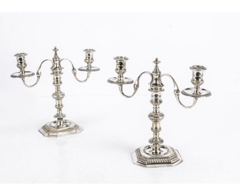 A pair of 1970s cast silver candlesticks, octagonal base with stem having three knops and sconce, with matching two branch ca