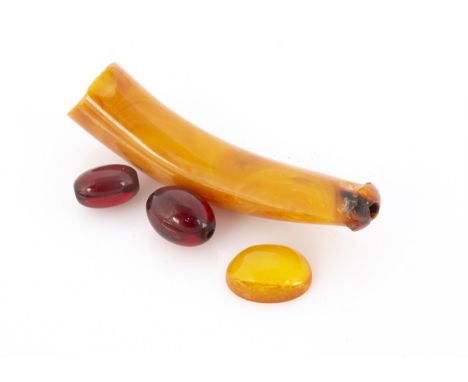 An amber hand cut mouth piece from a pipe, a cabochon Baltic amber gem and two 'cherry amber' beads 6.6g 