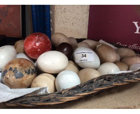 A collection of ceramic eggs; wooden eggs and other fruit