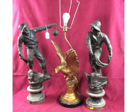A pair of French Spelter figures, of fishermen on wooden socles, 57cm and a gilt composition lamp base designed as an eagle, 