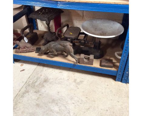 A set of cast iron balance scales; a pedestal trivet; flat irons etc.