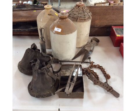 A collection of bygones, to include three stoneware flagons, various tools and rasps; a pair of leather hoof covers etc.