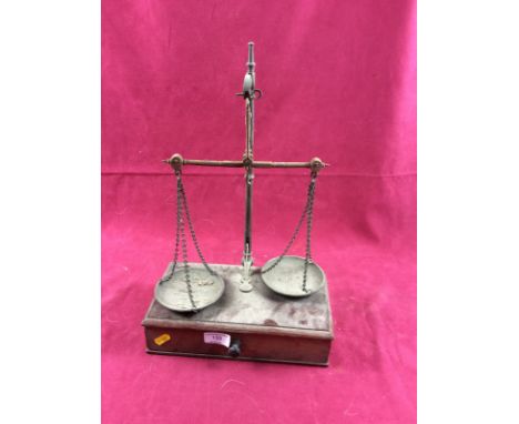 A set of brass and steel beam balance scales, on mahogany platform with a single drawer, 27cm