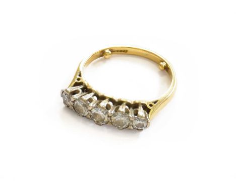 An 18 Carat Gold Diamond Five Stone Ring, the graduated round brilliant cut diamonds, in white claw settings, to a yellow tap