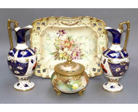 A Royal Worcester Pot Pourri Jar and Cover, painted with roses and raised on scroll supports, printed puce mark; together wit