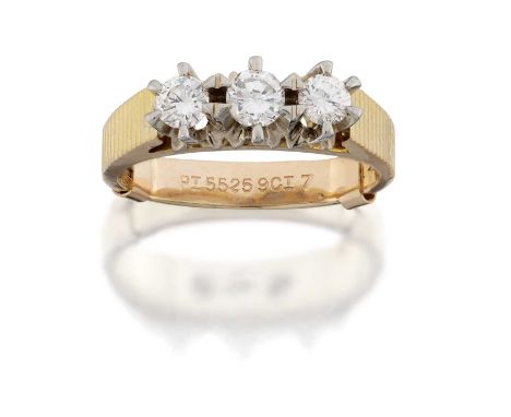 An 18 Carat Gold Diamond Three Stone Ring, the round brilliant cut diamonds in white claw settings, to yellow fancy tapered s