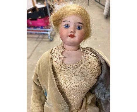 SFBJ 60 Bisque Socket and Shoulder Head Doll, with painted face, blond wig, on a white kid leather body, wearing a cream silk