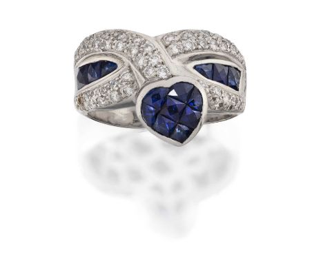 A Synthetic Sapphire and Diamond Ring, two crossover rows pavé set with round brilliant cut diamonds, spaced by calibré cut s