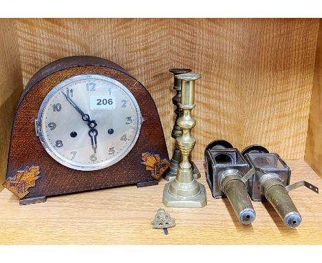 An oak mantel clock with a pair brass candlesticks and a pair of reproduction brass carriage lamps, clock H. 22cm.