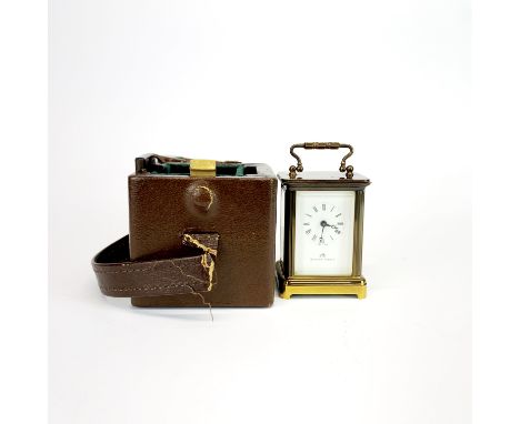 A miniature Matthew Norman brass carriage clock with original carrying case and key, H. 7.5cm.