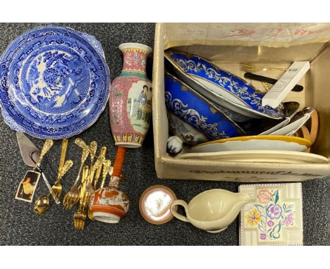 A box of Poole pottery and other items.