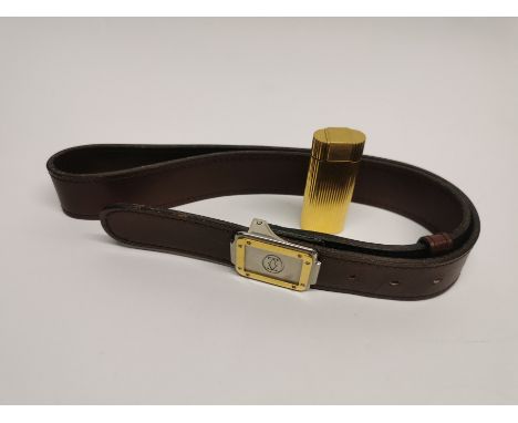 A Cartier gold plated lighter together with is Must de Cartier brown leather belt.