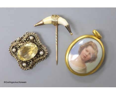   A Victorian yellow metal mounted glazed oval pendant, with miniature portrait of a young lady and plaited hair verso, 40mm,