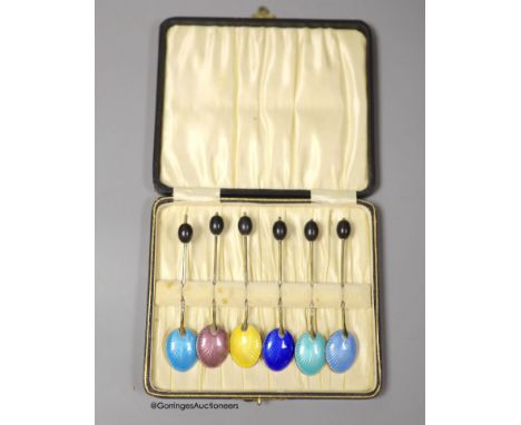   A late 1920's cased set of six continental silver and enamel bean end coffee spoons, import marks for George Stockwell, Lon