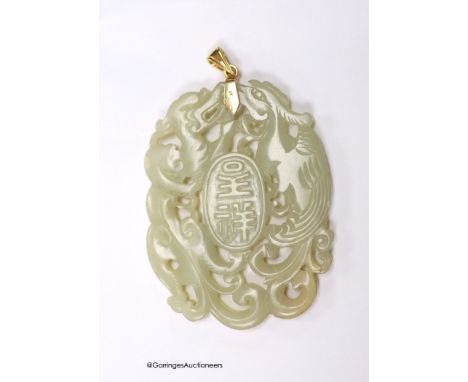   A Chinese yellow metal amounted jade pendant, 63mm, carved with dragons and character marks.