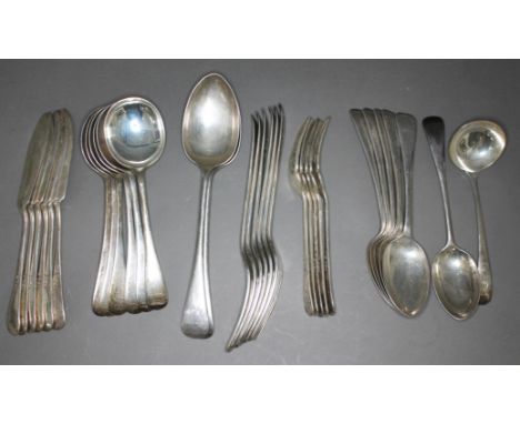 A set of silver flatware comprising six large forks, five fish forks, two serving spoons, five desert spoons, six soup spoons