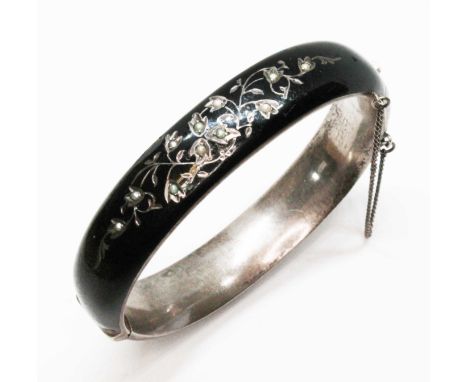 An Austrian/Hungarian black enamel and silver hinged mourning bangle, floral decoration set with pearls, Vienna .800 silver e