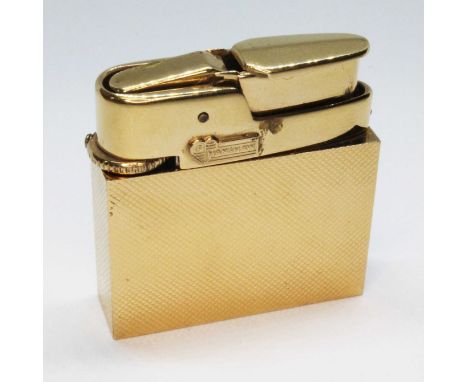 A Fred Manshaw textured gold cased gas lighter, marked 'FM' within a heart and '9.375', gold wt. 18.6g, with original box.  C