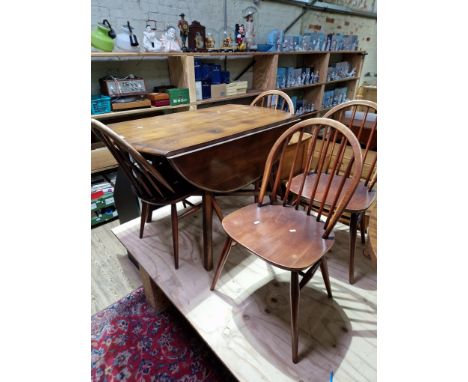 A vintage Ercol beech and elm drop leaf table and four Ercol 'Windsor' chairs.