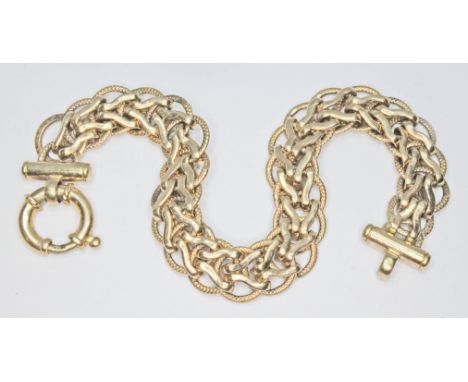 A fancy link bracelet with bolt ring clasp, marked '374', length 18cm, wt. 13.4g.  