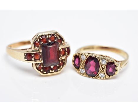 TWO 9CT GOLD GEM SET RINGS, the first designed with three graduated oval cut garnets, within a colourless paste set surround,