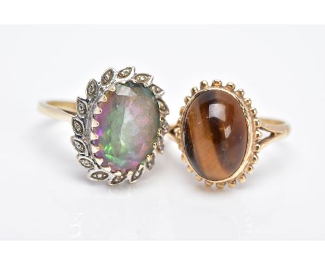 TWO 9CT GOLD GEM SET RINGS, to include a tiger eye cabochon, within a collet mound and a beaded surround, bifurcated shoulder