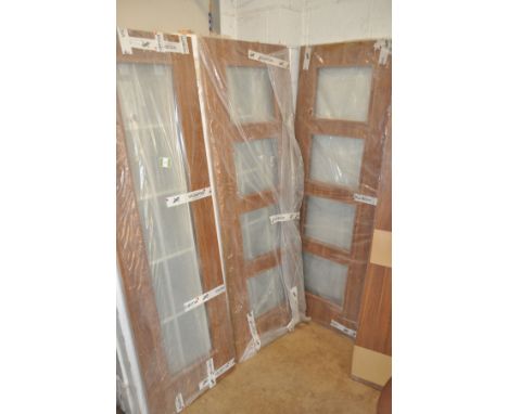 A COLLECTION OF THIRTY ONE WALNUT INTERIOR DOORS  to include one with a single long glaze width 61cm and two with four panel 