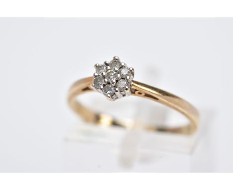 A 9CT GOLD DIAMOND RING, designed with a small cluster set with seven round brilliant cut diamonds, tapered shoulders, stampe