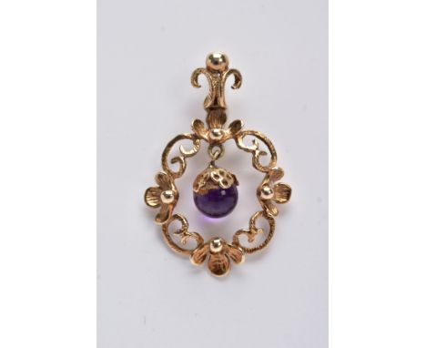 A 9CT GOLD AMETHYST DROP PENDANT, of an openwork floral and scroll detailed design, suspending an amethyst ball drop within t