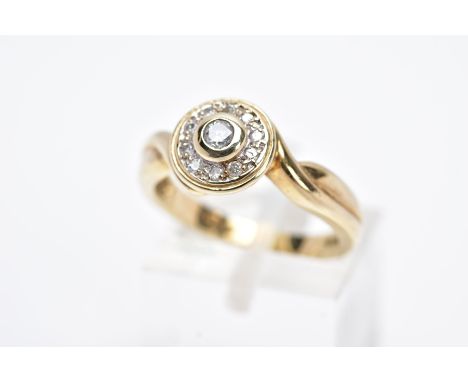 A 9CT GOLD DIAMOND RING, designed with a circular head with a central collet set round brilliant cut diamond, within a round 