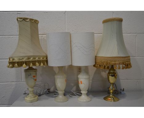 THREE VARIOUS ONYX TABLE LAMPS, and a brass table lamp, all with fabric shades (4)